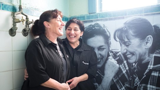 Sisters Rose Banks and Yvette Kelly, who took over the Gatwick from their mother, with their portrait in a bathroom.