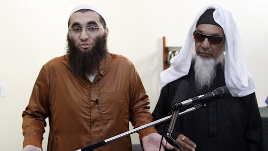 Roshan Abassi, left, a teacher at the Dar Al Uloom Al Islamiyah mosque in San Bernardino, and the mosque's founder, Mohammad Nadvi, answer questions from the media after prayer at the mosque in San Bernardino on Friday. Syed Rizwan Farook was known to pray every day at the mosque. 