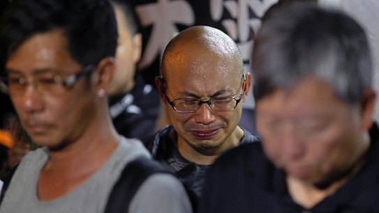 A protester cries as he mourns jailed Chinese Nobel Peace laureate Liu Xiaobo during a demonstration outside the Chinese liaison office in Hong Kong, on Thursday.