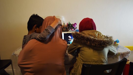 Nayser Ahmed (centre, on screen) Skypes in from Manus Island where he is in detention to his family in their home in Sydney.