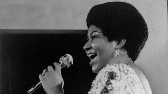 In this Jan. 28, 1972 file photo, vocalist Aretha Franklin sings a few notes into microphone.