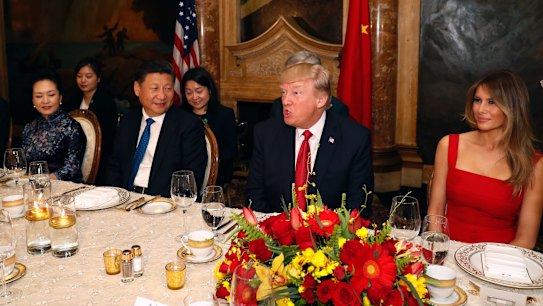 President Donald Trump and Chinese President Xi Jinping, with their wives, first lady Melania Trump and Chinese first lady Peng Liyuan are seated during a dinner at Mar-a-Lago.
