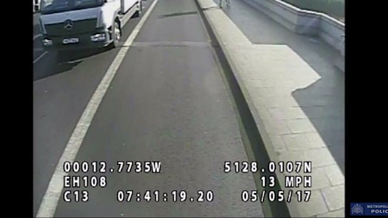 The woman was pushed into the road on Putney Bridge in London. An oncoming bus narrowly missed her head.