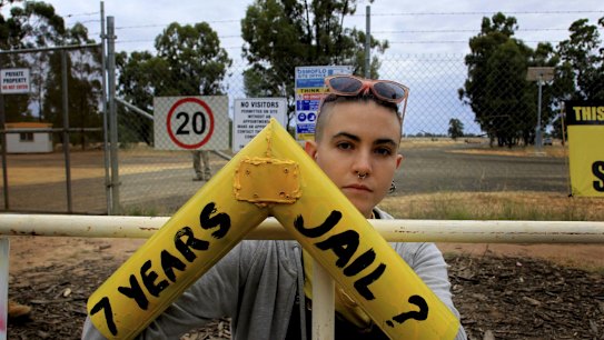 A protester locks on to a gate that is part of Santos' Narrabri CSG project.