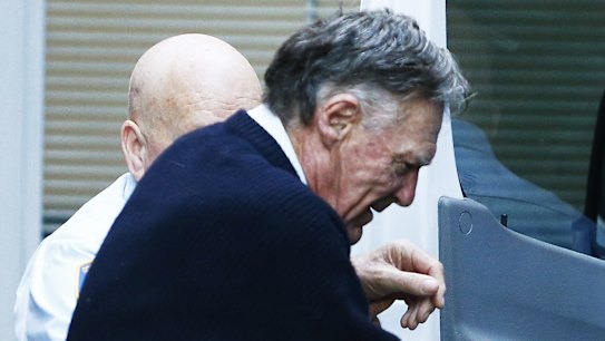 Ian Turnbull escorted out King Street court.