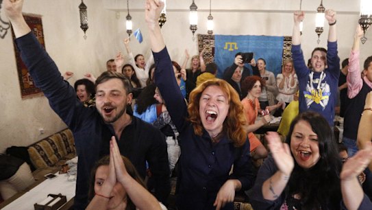 Ukrainians cheer while watching TV as Jamala wins the final of the Eurovision Song Contest.