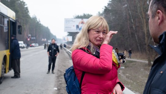 IRPIN, UKRAINE - MARCH 06: A wife says her goodbyes to her husband who is a member of the Territorial Defense as she evacuates from the city on March 6, 2022 near Irpin, Ukraine. Three civilians were killed and others were wounded as Russian mortar rounds landed between Irpin and Kyiv this morning, striking a route used by civilians fleeing southeast toward Kyiv. Russia continued its assault on Ukraine's major cities, including its capital, more than a week after launching a large-scale invasion of the country. (Photo by Anastasia Vlasova/Getty Images) *** BESTPIX ***