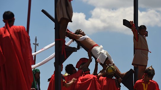 Reuben Enaje re-enacts Christ's crucifixion in Barangay San Pedro Cutud in Pampanga, north of Manila