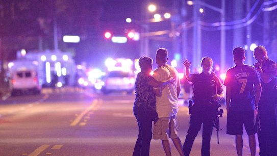 Orlando Police officers direct people away from a multiple shooting at the nightclub.  