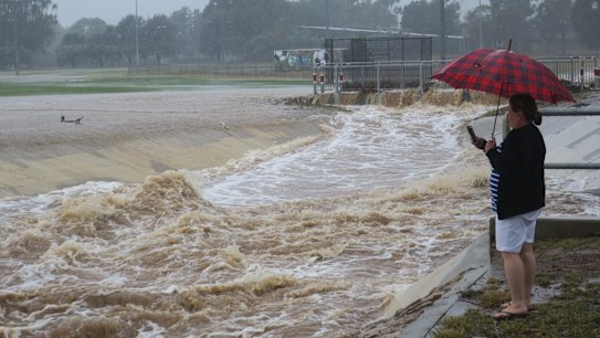 The storm water drain near Dickson oval was overflowing on Sunday morning.