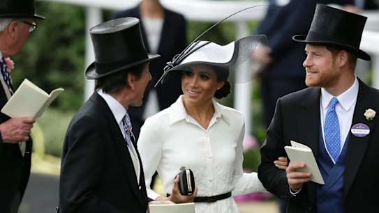 Britain's Prince Harry and Meghan, Duchess of Sussex, arrive on the first day of the Royal Ascot horse race meeting in Ascot, England, Tuesday, June 19, 2018. The Duchess' hat is by renowned Irish milliner Philip Treacy, and her dress is by Givenchy.  