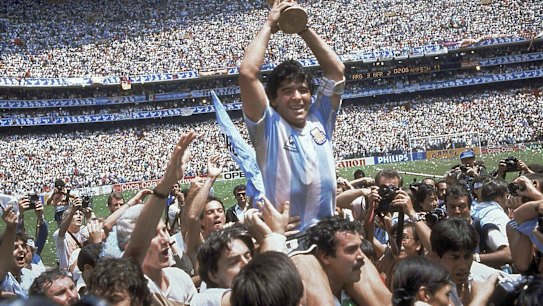 FILE - In this June 29, 1986 file photo, Diego Maradona holds up his team's trophy after Argentina's 3-2 victory over West Germany at the World Cup final soccer match at Atzeca Stadium in Mexico City. The Argentine soccer great who was among the best players ever and who led his country to the 1986 World Cup title before later struggling with cocaine use and obesity, died from a heart attack on Wednesday, Nov. 25, 2020, at his home in Buenos Aires. He was 60. (AP Photo/Carlo Fumagalli, File)