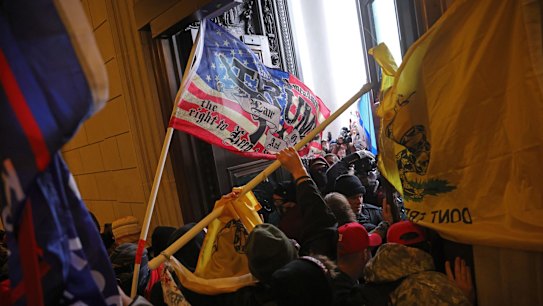 WASHINGTON, DC - JANUARY 06: Protesters supporting U.S. President Donald Trump break into the U.S. Capitol on January 06, 2021 in Washington, DC. Congress held a joint session today to ratify President-elect Joe Biden's 306-232 Electoral College win over President Donald Trump.  Pro-Trump protesters entered the U.S. Capitol building during demonstrations in the nation's capital.  (Photo by Win McNamee/Getty Images) .