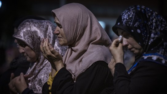Women are overcome with emotion at a vigil for those who have died in the earthquake in Turkey and Syria.