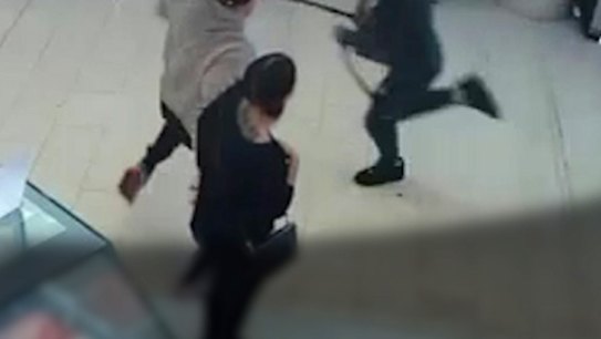 CCTV footage from a gelato store shows how a bystander tripped a man wielding a machete at a suburban shopping centre in Melbourne.