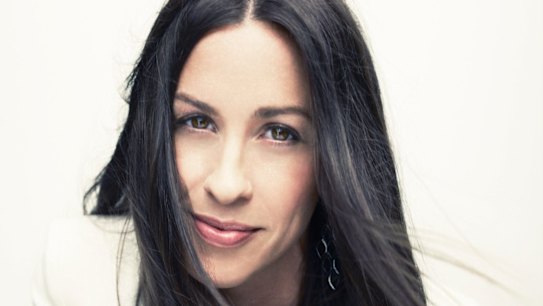 Morissette still sports her trademark long locks and centre part.