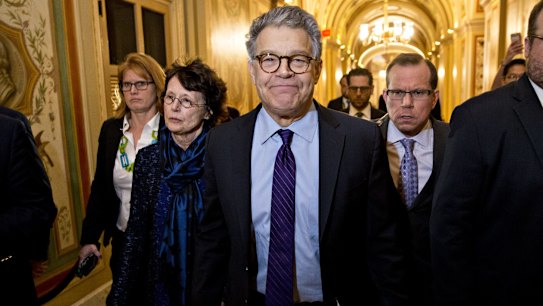 Senator Al Franken, flanked by his wife Franni Bryson, arrives in the US Capitol to announce his resignation. 