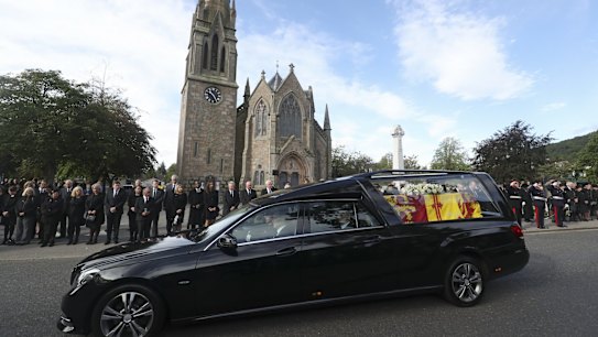 Members of the public line the streets in Ballater, Scotland, as the hearse carrying the coffin of Queen Elizabeth II passes through as it makes its journey to Edinburgh from Balmoral in Scotland.