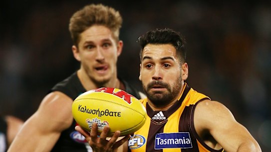 The Hawks' Paul Puopolo stays one step ahead of Port Adelaide's Hamish Hartlett in the round 16 match at Adelaide Oval. 