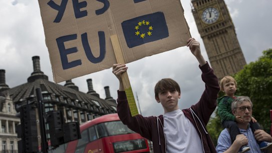 A small group of young people gather to protest on Parliament Square the day after a majority of the British public voted for leaving the European Union.