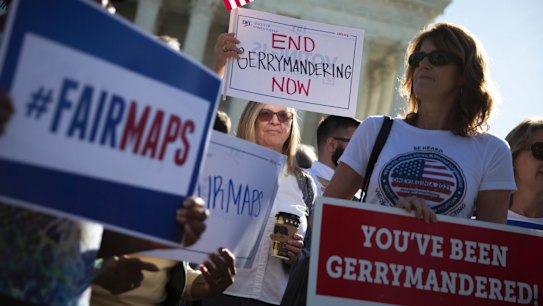 People demonstrate outside the US Supreme Court as justices heard arguments in a previous key gerrymandering case, in October.