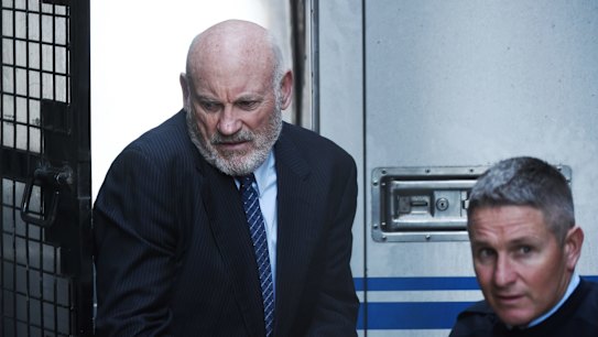 Ian Macdonald is led into the Supreme Court on Friday to be sentenced. 