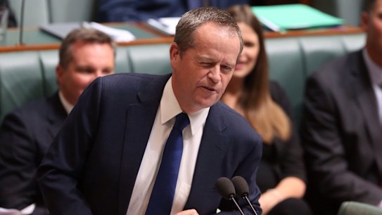 Opposition Leader Bill Shorten winks at Malcolm Turnbull while seeking to move a motion of no confidence in Prime Minister Tony Abbott during question time. 