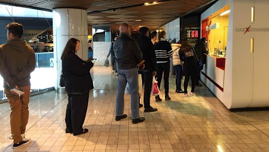 People queue at a currency exchange store in central Sydney to get their hands on pounds.