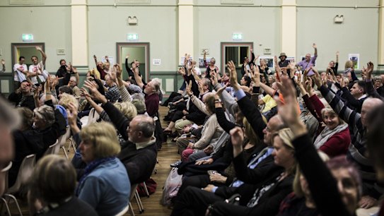 Attendants at a Stop WestConnex meeting at the Balmain Town Hall demonstrate the local opposition to the project. 