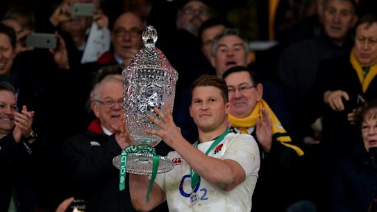 Dylan Hartley of England lifts the trophy after the final whistle.