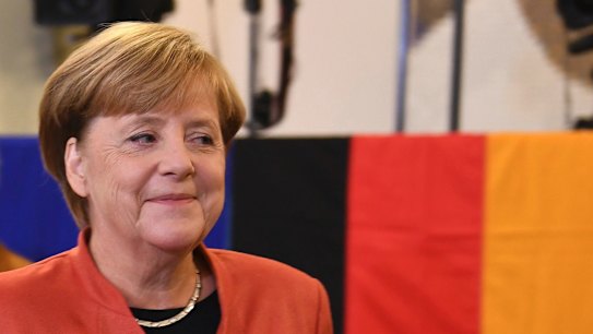 German Chancellor Angela Merkel smiles as she casts her vote in Berlin.