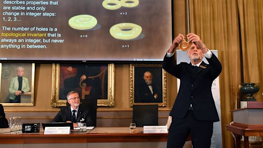Professor Thors Hans Hansson gives a demonstration after revealing the winners of the Nobel prize in physics in Stockholm.