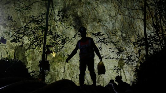 Rescuers make their way down at the entrance to a cave complex where 12 boys and their soccer coach went missing, in Mae Sai, Chiang Rai province, in northern Thailand.