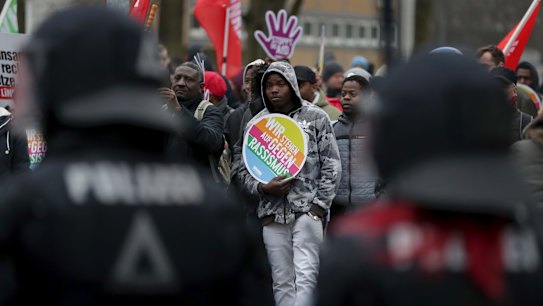 Police officers observe a protest rally against a party convention of anti-migration party the Alternative for Germany, AfD, party in Hannover, Germany.