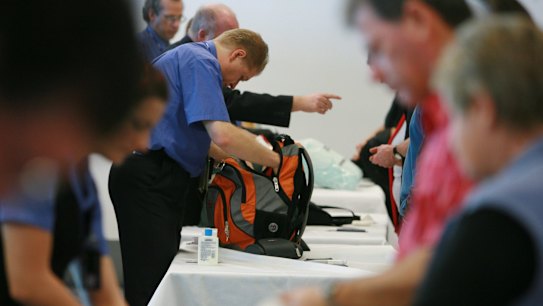 Security at Los Angeles airport conducts a search on carry on baggage.