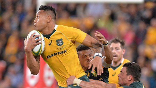 Shackled: Israel Folau attempts to break away from the Boks' defence.