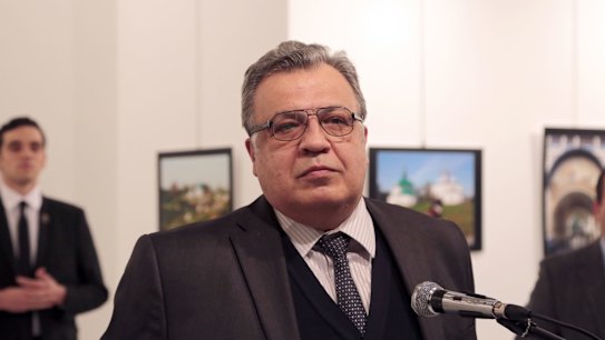 Russian Ambassador to Turkey Andrei Karlov makes an address at the gallery moments before he is shot by Mevlut Mert Altintas, seen in the background.