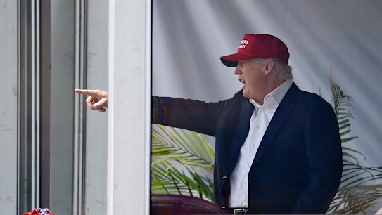 President Donald Trump reacts to spectators as he watches the third round of the US Women's Open Golf tournament in Bedminster, New Jersey, on Saturday
