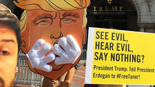 Members of Amnesty International protest outside Trump International Hotel in Washington in  June.