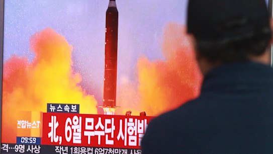 A man watches a TV news program on North Korea's missile launches at Seoul Railway Station, South Korea.