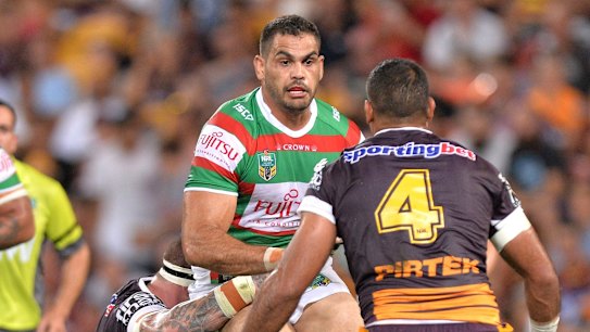 BRISBANE, AUSTRALIA - MARCH 05: Greg Inglis of the Rabbitohs takes on the defence during the round one NRL match between the Brisbane Broncos and the South Sydney Rabbitohs at Suncorp Stadium on March 5, 2015 in Brisbane, Australia.  (Photo by Bradley Kanaris/Getty Images)