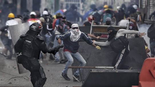 Demonstrators clash with the police during an anti-government protest in Cali, Colombia, as the county marks its Independence Day.