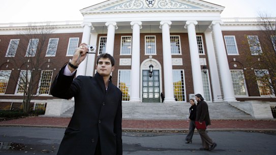 An unidentified man takes a photograph at the Harvard Business School in Boston, Massachusetts. The city has a history of innovation.