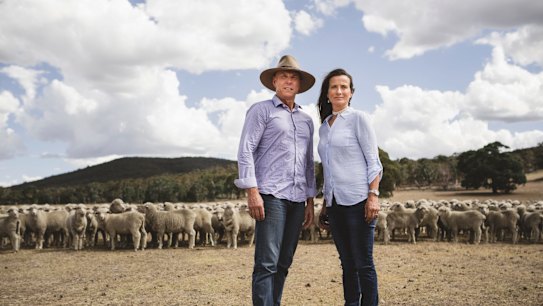 Local farmers John Reardon and Tina Freund stand on their property, just over a ridge from the range.