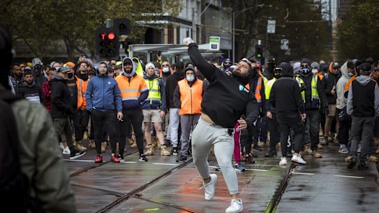 A protester throw a projectile at Victorian Police. 