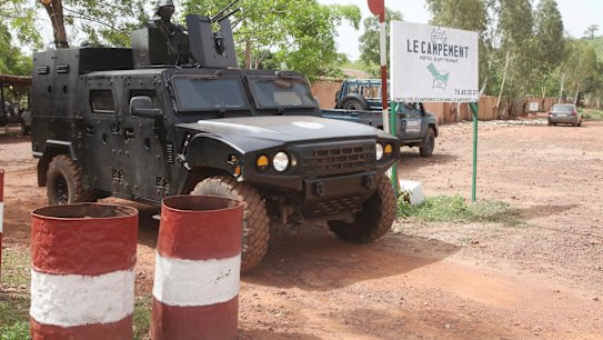 A Malian police officer stationed on an armoured personnel vehicle outside Campement Kangaba, Bamako.