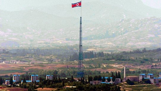 A giant North Korean flag flutters on the top of a tower in North Korea seen from the Demilitarised Zone near the border village of Panmunjom.
