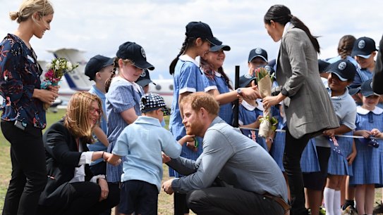 Britain's Prince Harry, the Duke of Sussex has his beard tickled by school student Luke Vincent of Buninyong Public School as His Royal Highness and his wife Meghan, the Duchess of Sussex arrive at Dubbo Regional Airport in Dubbo, Australia, Tuesday, October 17, 2018. The Duke and Duchess of Sussex are on a 3-week tour of Australia, New Zealand, Tonga, and Fiji and are in Sydney to launch the 2018 Invictus Games, an Olympic-style event for disabled and ill service people. (AAP Image/Dean Lewins) NO ARCHIVING