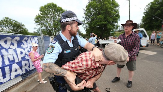 Police remove protestors from the Windsor Bridge construction site on Monday.