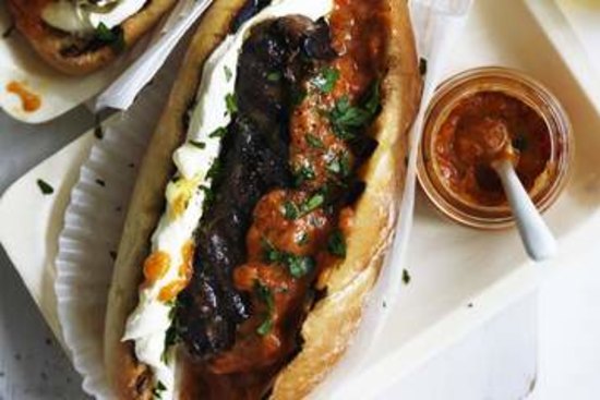 Cevapcici rolls with sweet ajvar and sour cream.